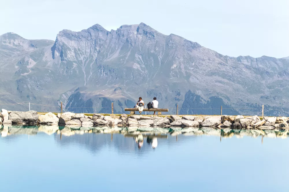 lake, people, and mountains all compressed in a single scene with a telephoto