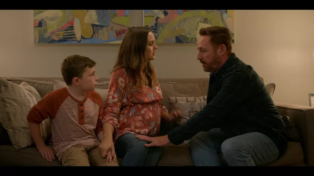 Gordon spends a final few moments with his family before they are erased from existence