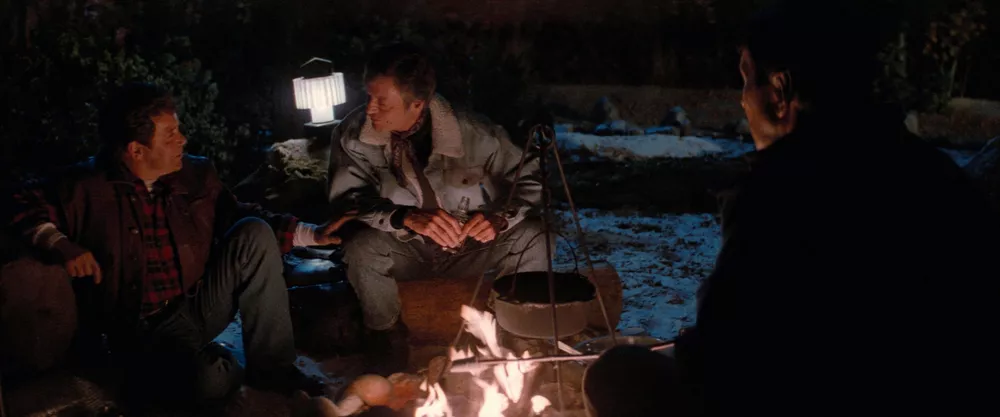 Kirk, Spock, and McCoy sitting around a campfire